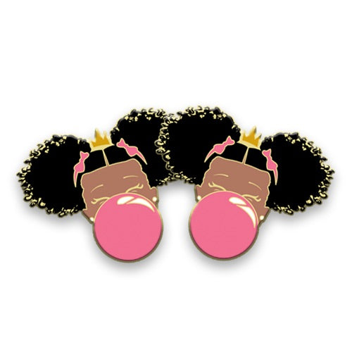 black girl with two afro puffs blowing a bubble